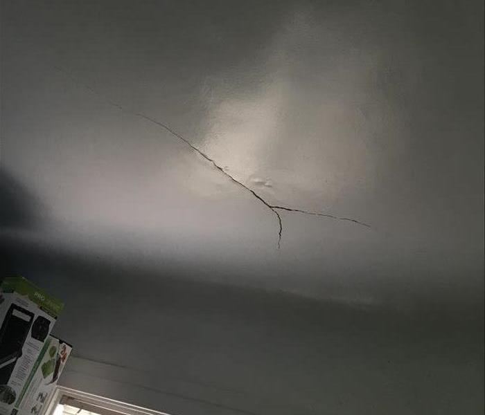 Roof leak storm damage causes water damage in ceiling and attic that caused crack roof and ceiling.