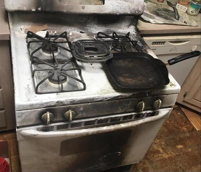 Chula Vista, San Diego kitchen fire causes extreme fire and smoke damage to cabinets and surrounding areas in kitchen.