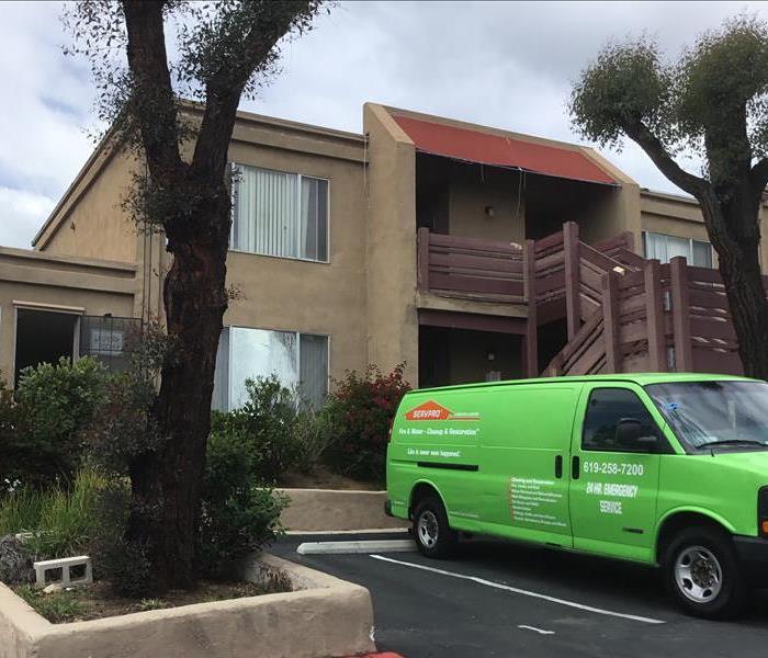 SERVPRO van car parked in front of customer or client's apartment / condo building ready to assist in water mold fire damage